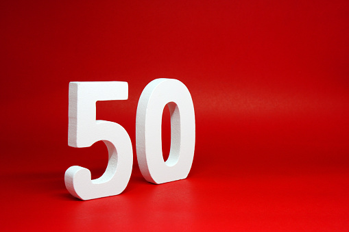 Fifty ( 50 ) white wooden  Isolated Red Background with Copy Space - New promotion 50% Percentage  Business finance Concept