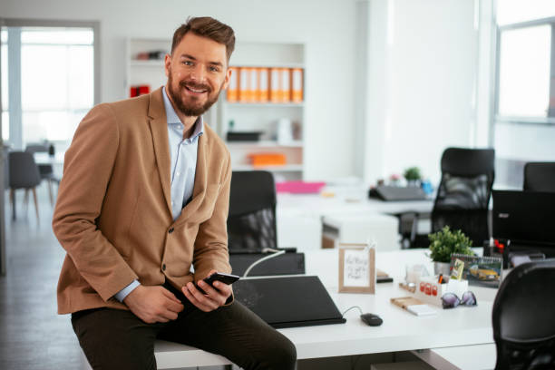 istock Manager sitting on the desk, using the phone. 1296506526