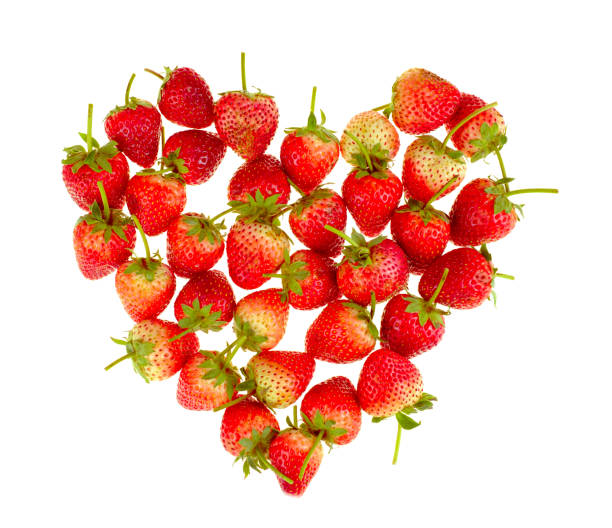 istock Fresh strawberries in a heart shape isolated on white background 1296515153