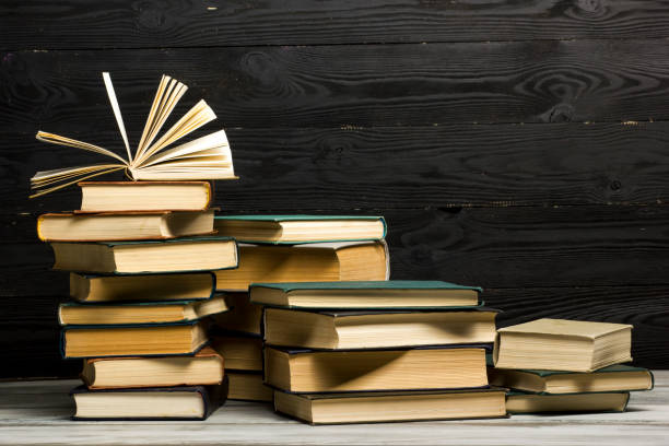istock Open book, hardback books on wooden table. Back to school. Copy space. 1296515190
