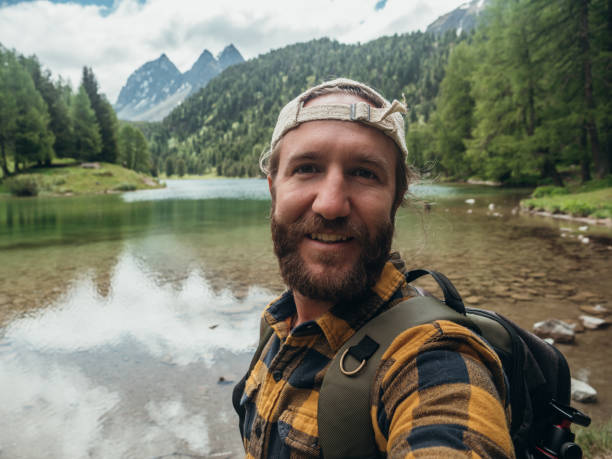 Man takes selfie at alpine lake