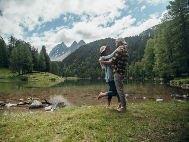 istock Couple hug by the lake in Summer, affectionately 1296515368