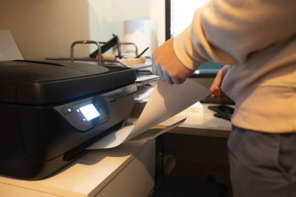 Someone Using The Printer 500+ Person Using Printer At Home Stock Photos, Pictures & Royalty-Free ...