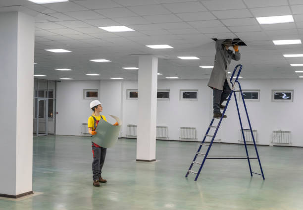 istock Workers on a ladder check the electrical wires on the ceiling. 1296518632