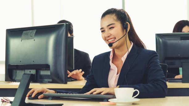 istock Business people wearing headset working in office 1296519709