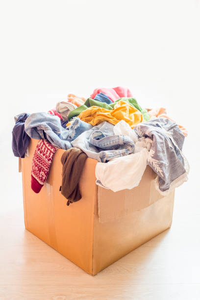 istock Pile of clothes in a large cardboard box 1296520152