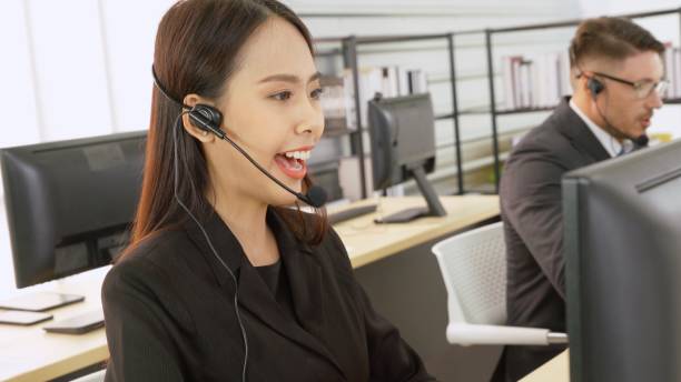 istock Business people wearing headset working in office 1296522851