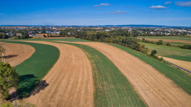 istock Aerial View of Multiple Farms and Train Tracks going Thru Them 1296525133