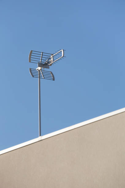 roof top antenna against a clean blue sky, braga, portugal. - television aerial roof antenna city imagens e fotografias de stock