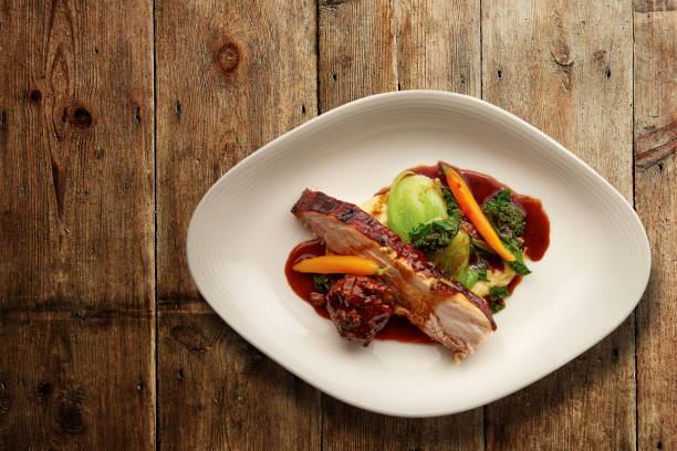 Overhead shot of a gourmet plate of sliced roast pork