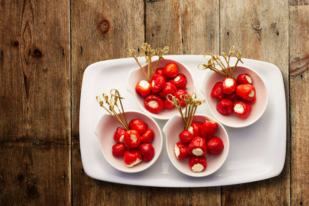 Ricotta stuffed peppers Top view of four bowls of Ricotta stuffed peppers in a serving tray hungarian pepper stock pictures, royalty-free photos & images