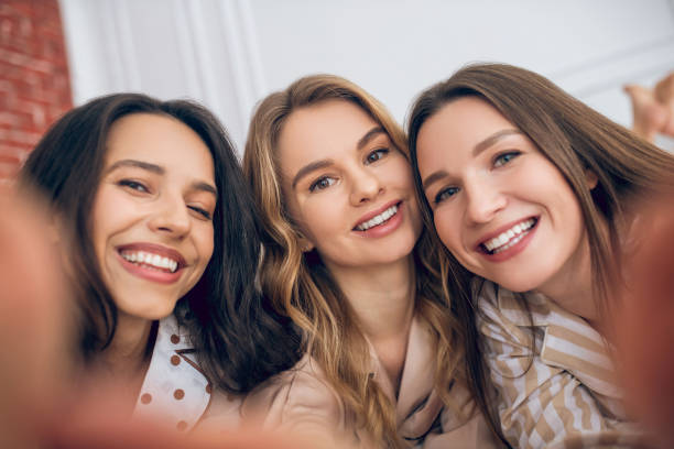 istock Three girls making selfie and looking happy 1296529188