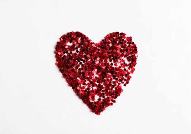 istock Greeting card heart made of red confetti on a white background 1296530173