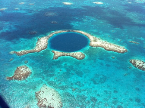 The Great Blue Hole off the coast of Belize is seen from a helicopter on a lovely spring day.