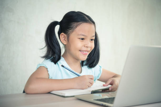 istock Asian girl student online learning class study online video call zoom teacher. 1296532002