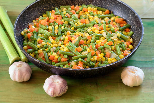 Mix of vegetables fried in a wok.