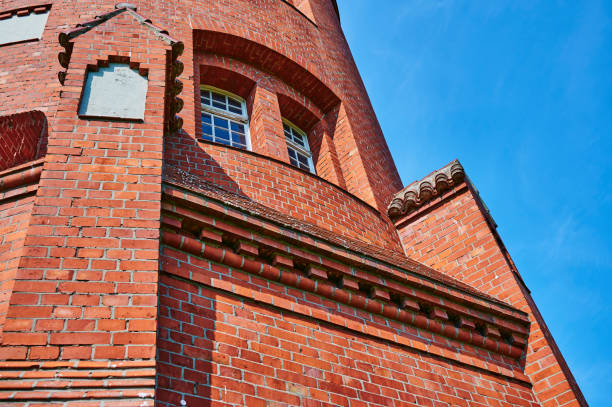 istock Details of a historic red brick water tower. 1296532850
