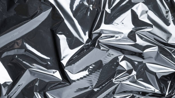 istock Plastic texture background. Wrap transparent dark cellophane. Cellophane black shiny film bag pattern. Creative crumpled background. 1296535166