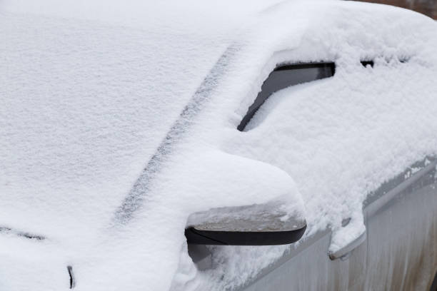 istock silver car covered with thick layer of snow at cloudy day light - close-up 1296536974