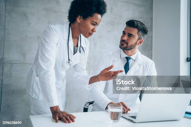 Two Doctors Conversation Two Doctors Having Conversation Over A Case In Doctors Office Stock ...