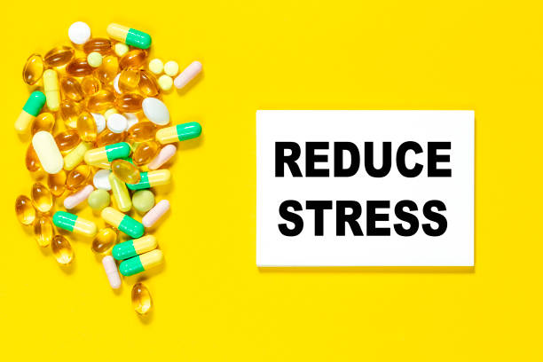 the word reduce stress is made card on a yellow background with colored pills. medical concept. - organic single word environment block imagens e fotografias de stock