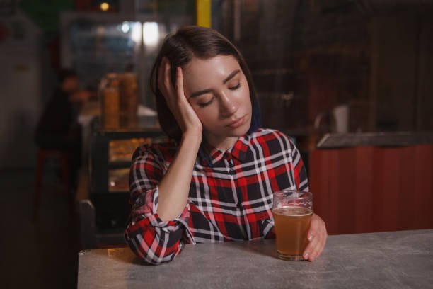 istock Woman drinking at beer pub 1296542093