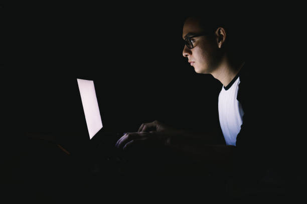 istock Workaholic young man working late night from home on his laptop 1296542280