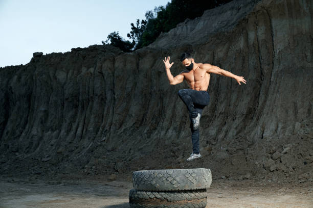 istock Healthy and active man workout alone at sand quarry 1296543348
