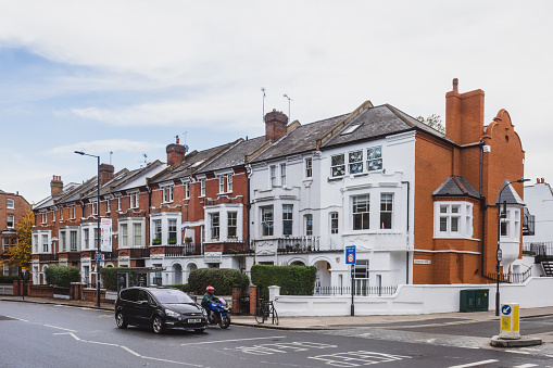 London, UK - 25 October 2020: Car and motorcycle waiting at crossroads in Fulham