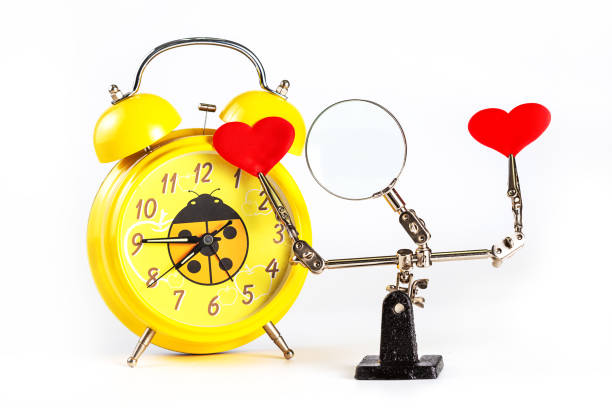 istock Abstract Valentines Day background with engineering tool third hand holding hearts and alarm clock on white background 1296543831