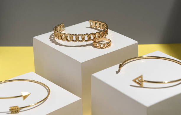 istock Close up on chain shape bracelet and ring with arrow shape bracelet on white display 1296552059