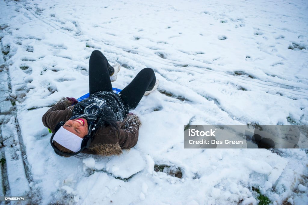 Filipino Female Sledging in South Yorkshire Enjoying Sledding in the UK Snow Filipino Female Having Fun Sledging in the UK Snow, Sledding, South Yorkshire, England, January 2021 Only Women Stock Photo