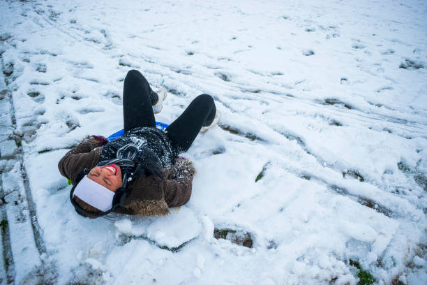 Filipino Female Sledging in South Yorkshire Enjoying Sledding in the UK Snow stock photo