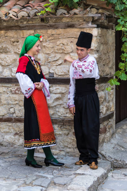 istock Beautiful young people in national costumes 1296554677