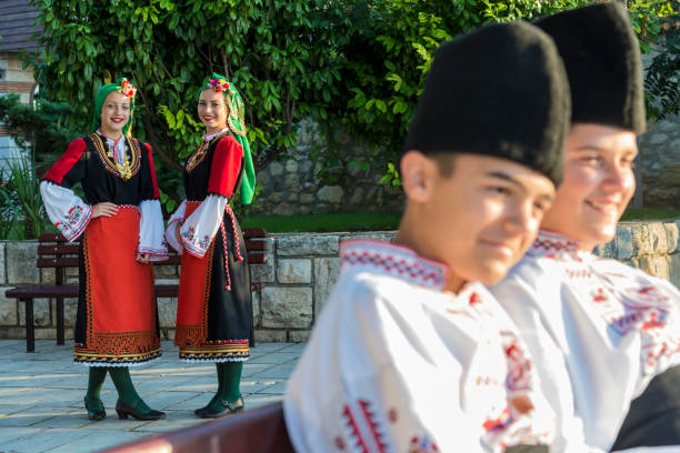 istock Beautiful young people in national costumes 1296554680