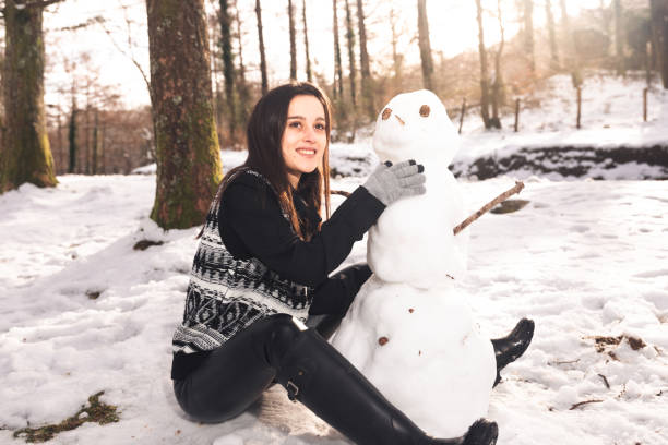 istock Girl building a snowman 1296556282