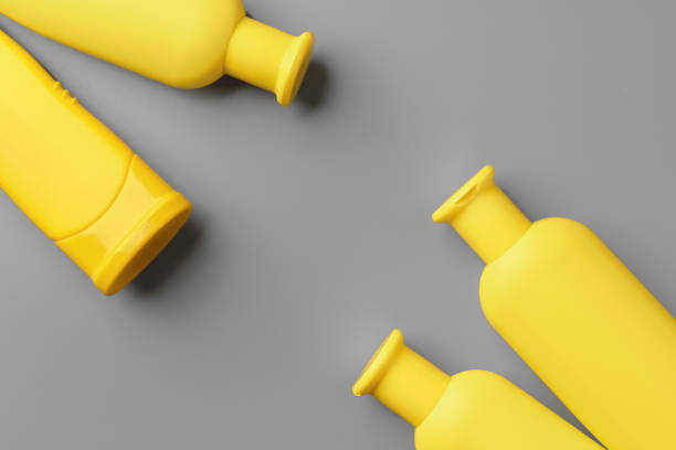 istock Yellow cosmetic container on gray background top view 1296556326