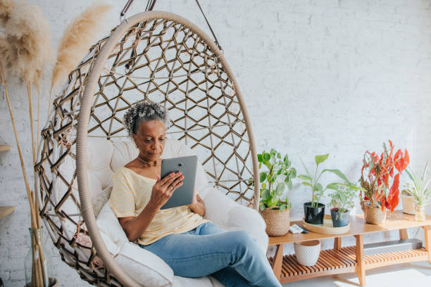 istock A senior woman using the digital tablet at home 1296556659