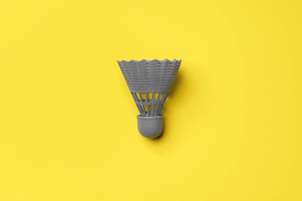 istock Gray shuttlecock on yellow background top view 1296557106