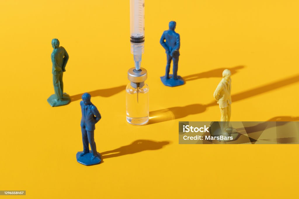 Anti-vaxxer anti-vaccination concept on yellow Concept image of people rejecting a vaccine injection Anti-vaccination Stock Photo