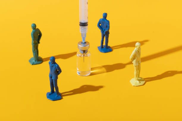 Anti-vaxxer anti-vaccination concept on yellow Concept image of people rejecting a vaccine injection anti vaccination photos stock pictures, royalty-free photos & images