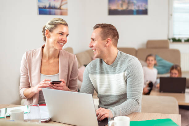 istock Cheerful man and woman working from home 1296558633
