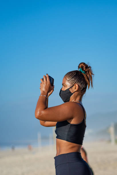 istock Woman working out on the beach 1296559267