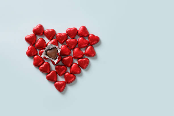 istock Red chocolate sweets as heart on blue. Valentine's day. 1296561588
