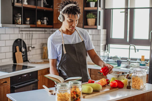 istock Young African American man is cooking in the kitchen 1296564853