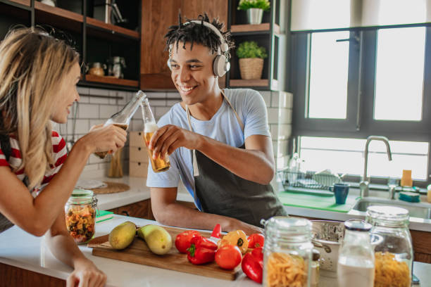 istock Friends are drinking beer and cooking in the kitchen 1296564947