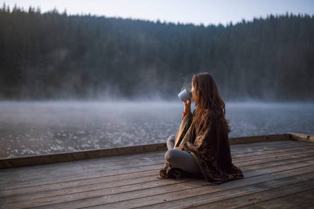 istock Woman Drinking Coffee In Nature At Sunrise. 1296565580