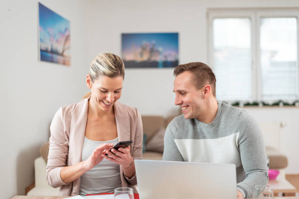 istock Cheerful couple working from home 1296565745