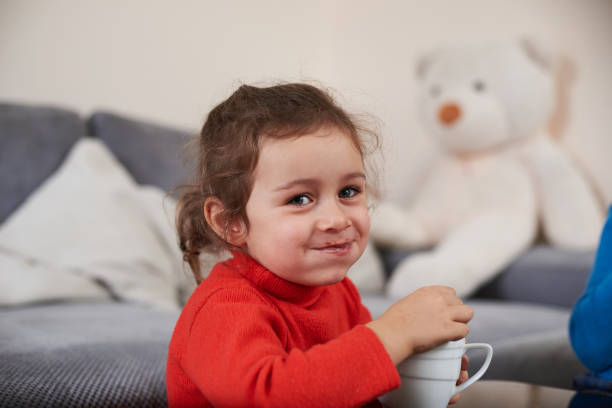 istock A smiling girl feelling happy while drinking a delicious cocoa with marshmellows 1296568319