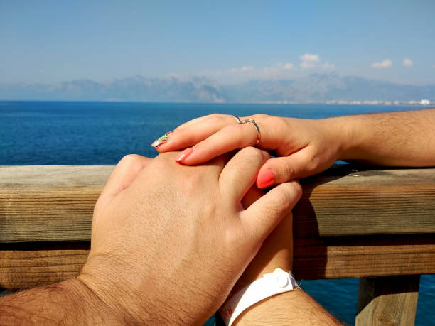 istock two female and male hand held together 1296569023